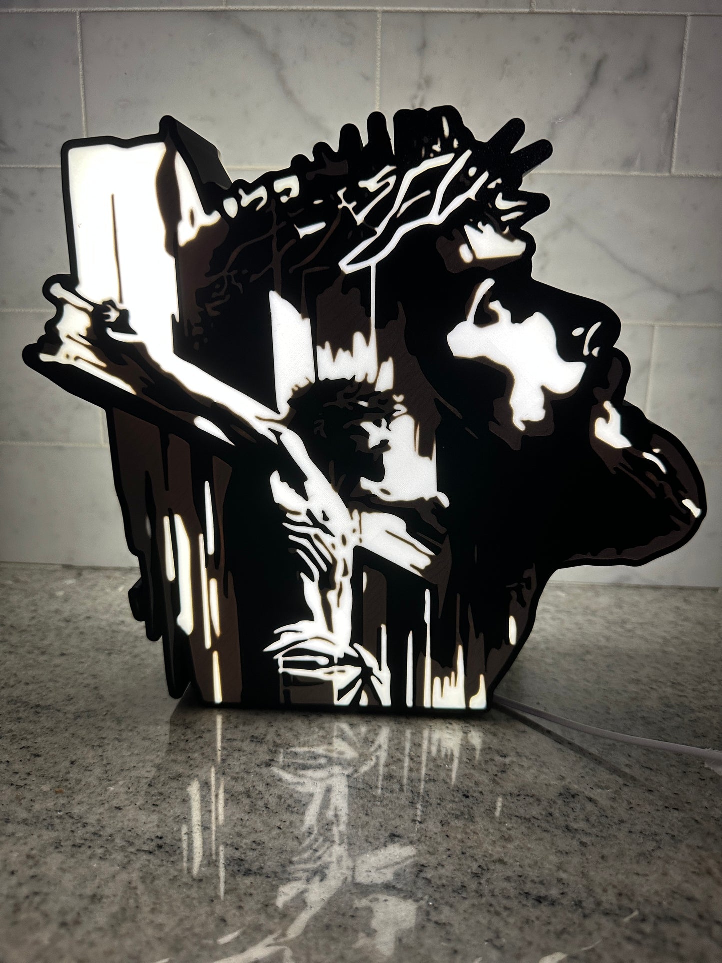 Back Light image of Christ on and Cross and looking up